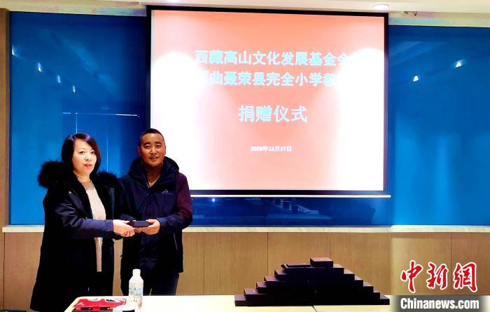 圖為西藏高山文化發展基金會理事長溫麗向聶榮縣完全小學負責人捐助儀器。　于賓 攝